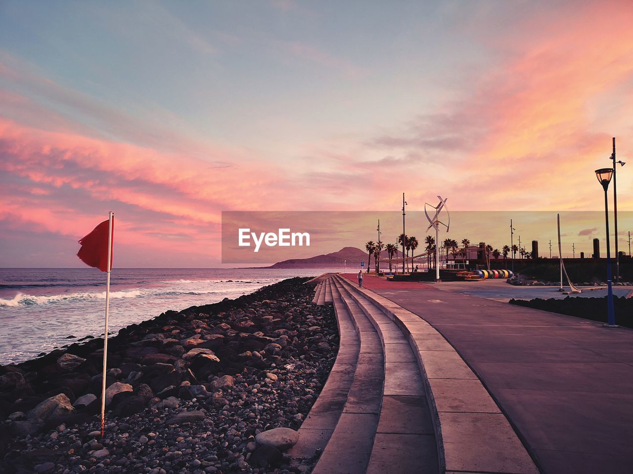 Scenic view of beach against sky during sunset