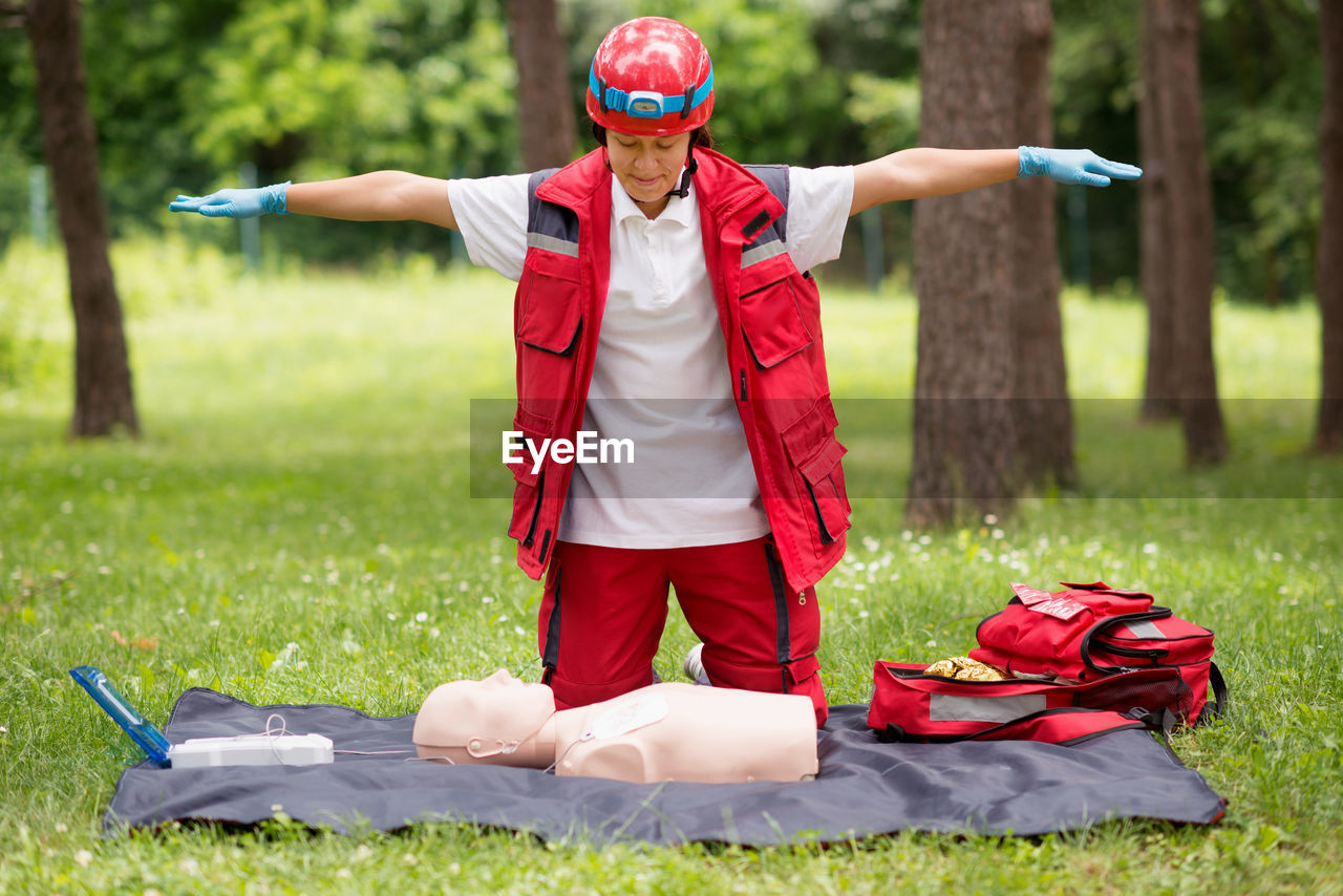 Healthcare worker practicing on cpr dummy at park
