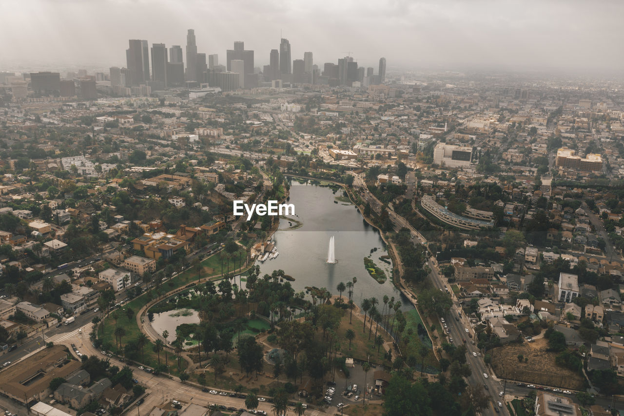 Echo park in los angeles with view of downtown skyline and foggy polluted smog air in big urban city