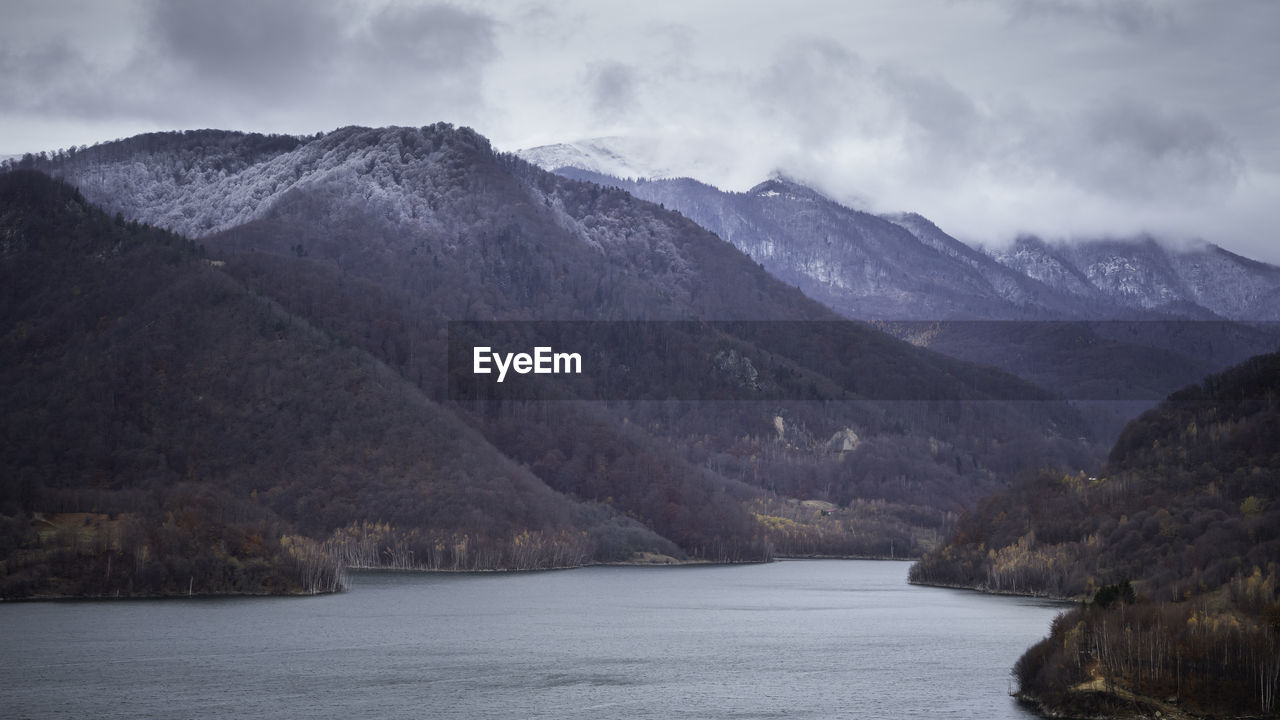 Scenic view of lake and mountains against sky