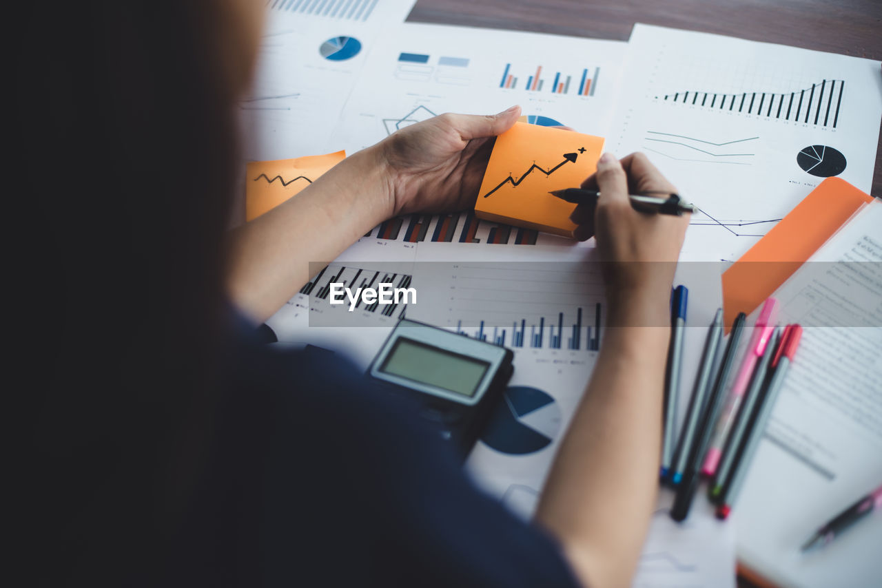 Close-up of businesswoman analyzing document in office