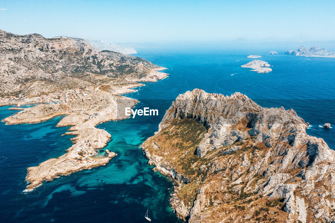 High angle view of rocks on shore against sea