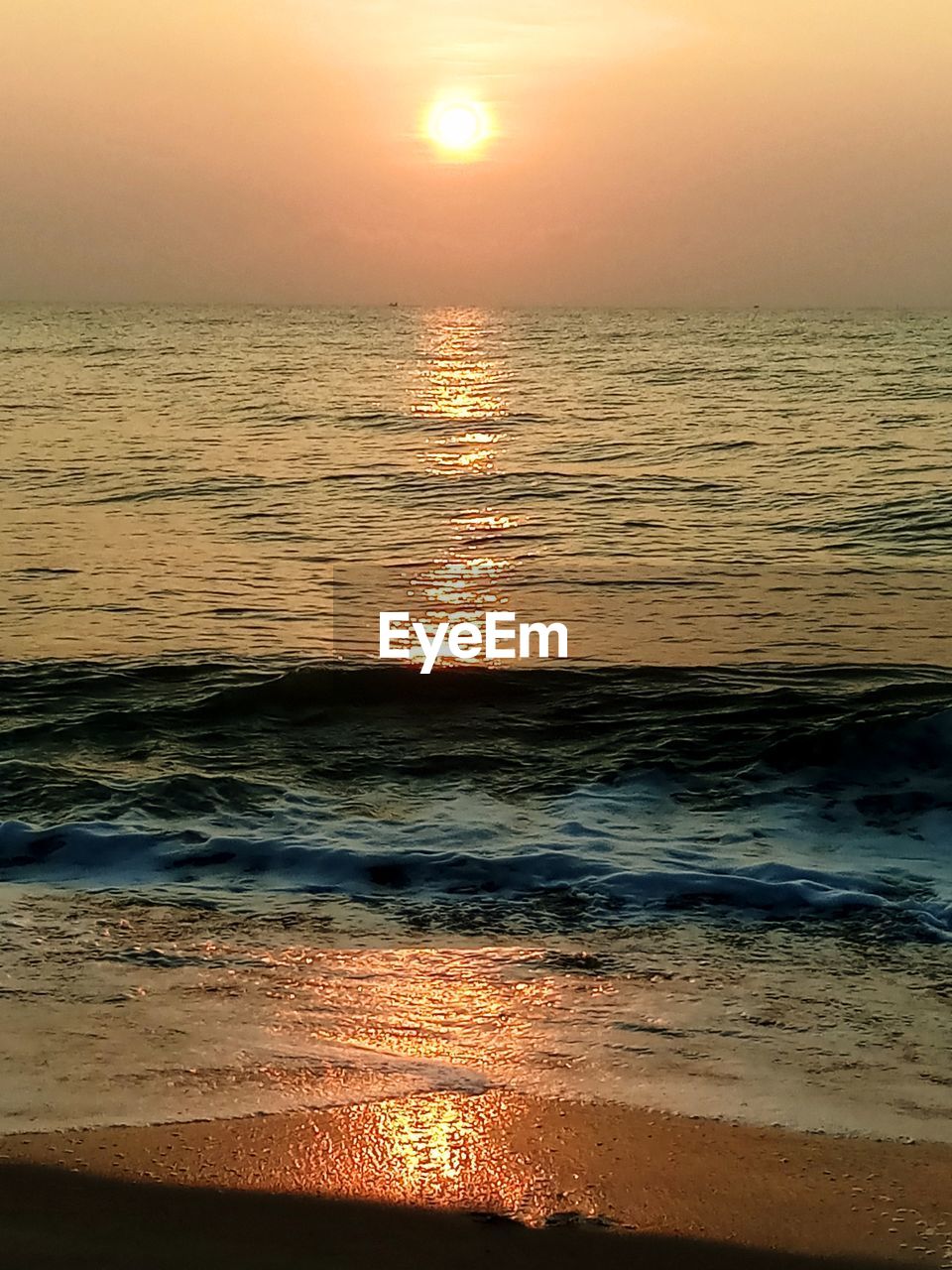 SCENIC VIEW OF BEACH DURING SUNSET