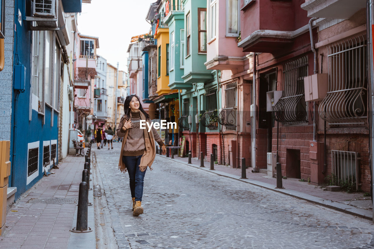 rear view of woman walking on street