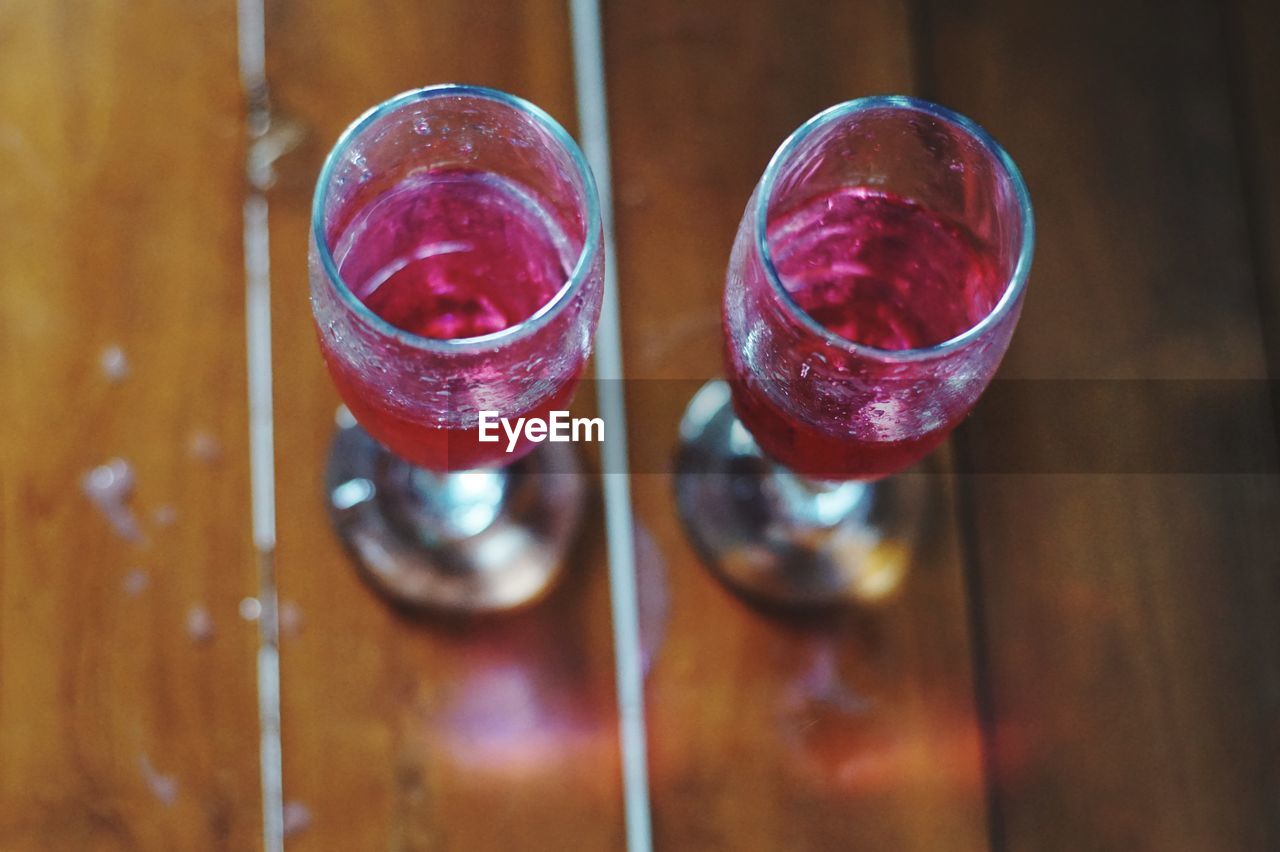 HIGH ANGLE VIEW OF WINE GLASS ON TABLE