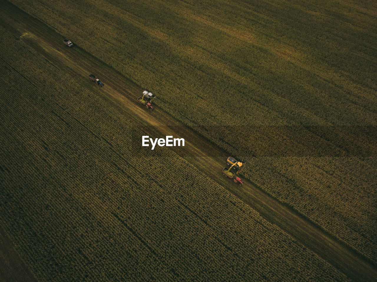 Aerial view of machinery working in agricultural field