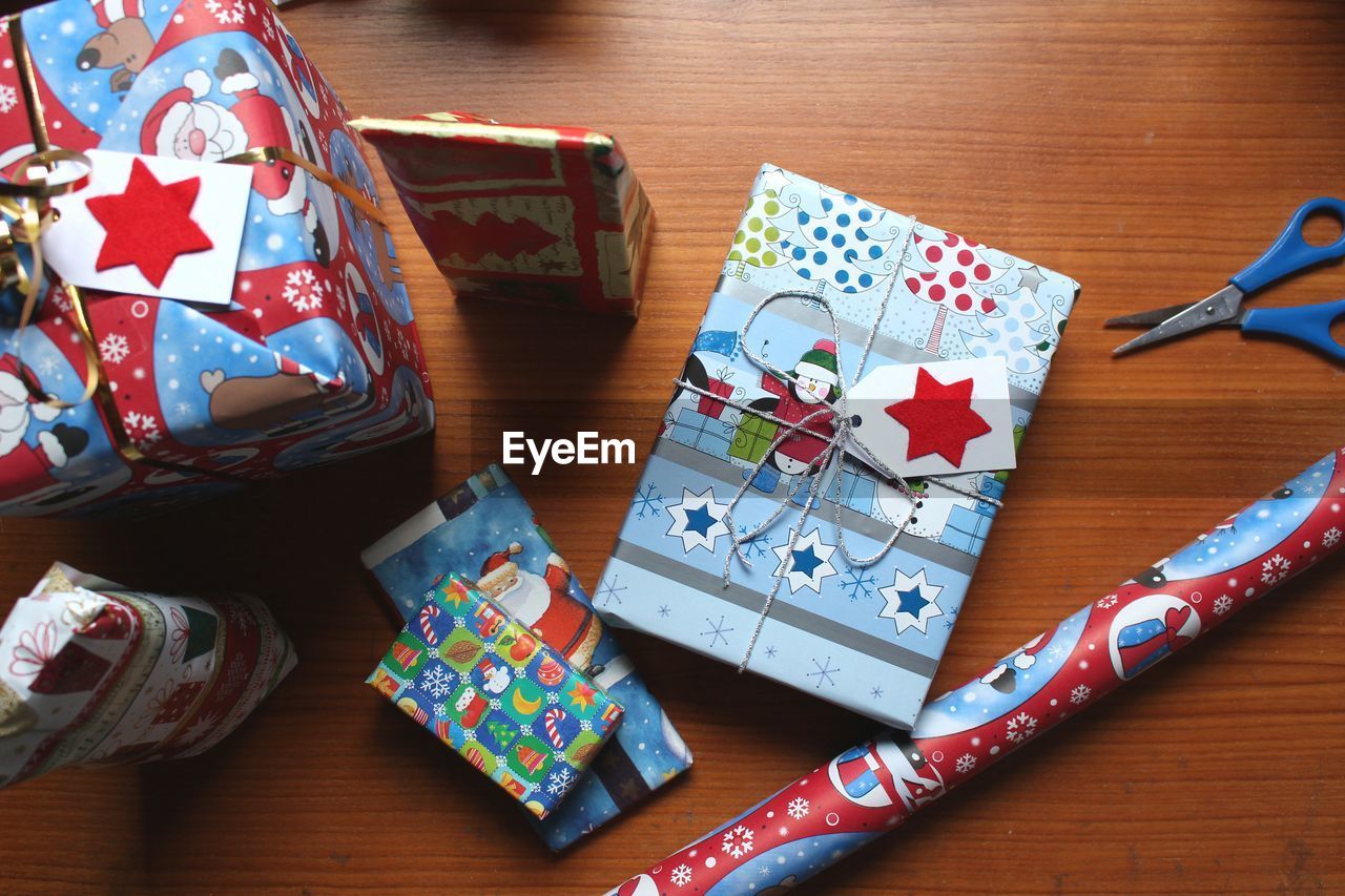 Directly above shot of christmas gifts on wooden table