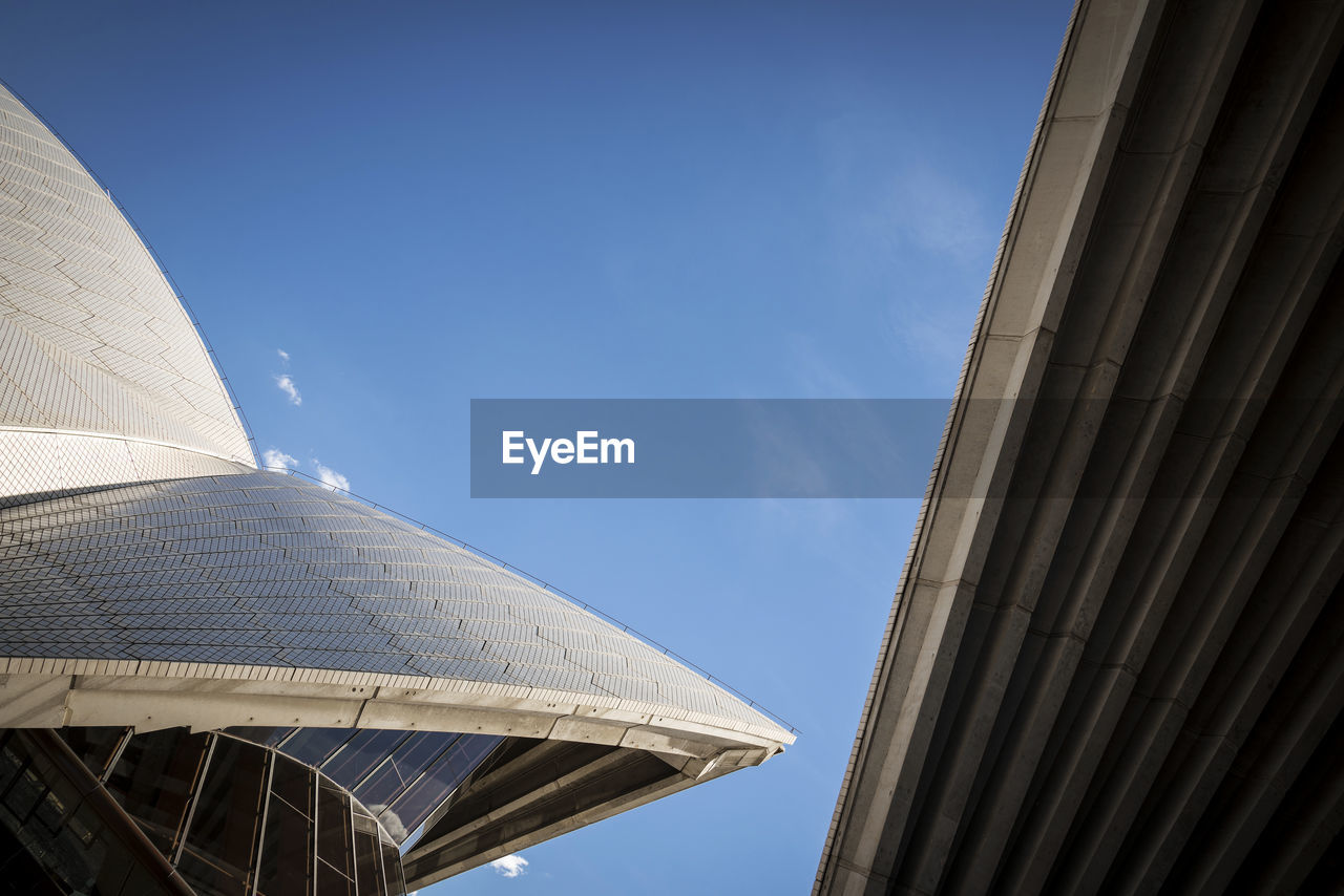 LOW ANGLE VIEW OF MODERN BUILDINGS AGAINST CLEAR BLUE SKY