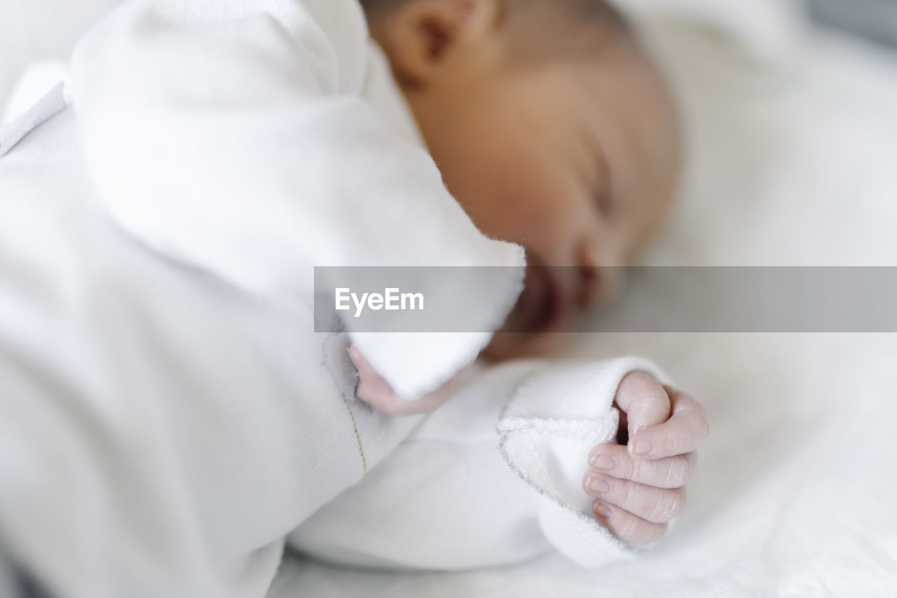 Newborn baby sleeping on bed