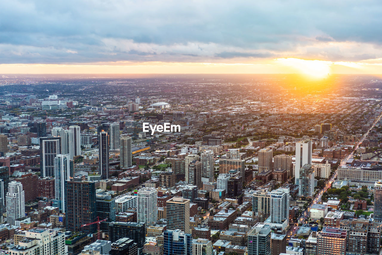 HIGH ANGLE VIEW OF MODERN BUILDINGS IN CITY AGAINST SKY