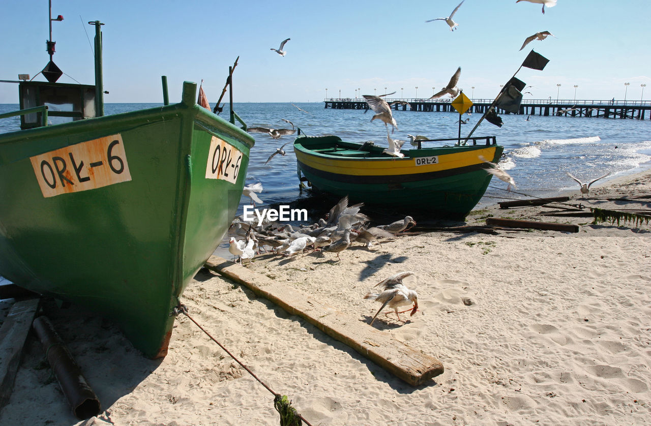 BOATS MOORED ON BEACH