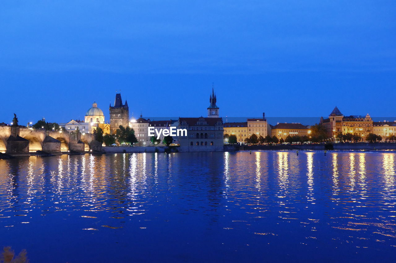 ILLUMINATED BUILDINGS AT WATERFRONT