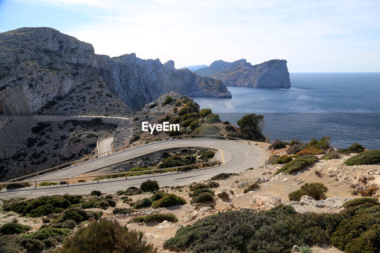 Scenic view of sea and mountains against sky