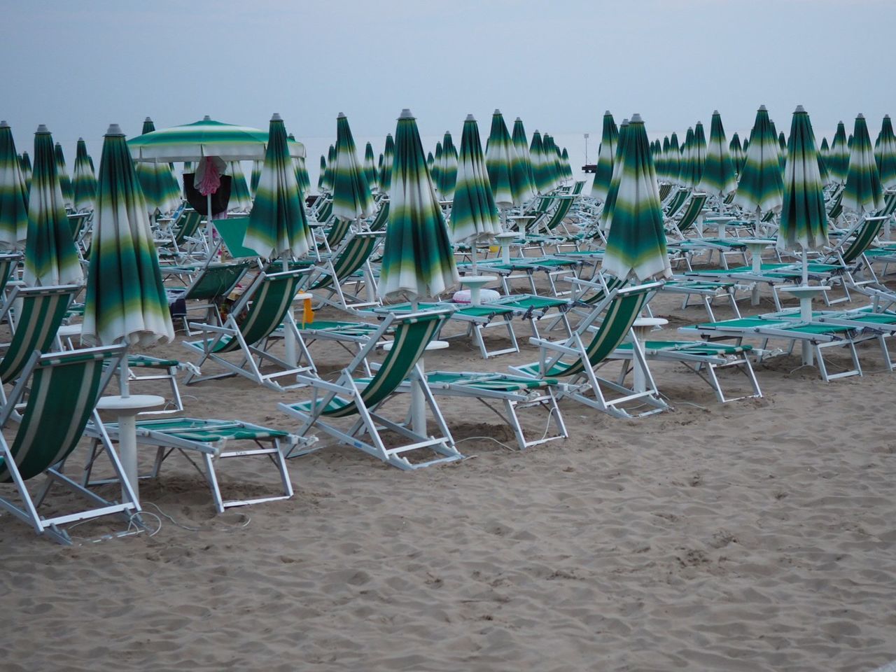 CHAIRS ON SAND AT BEACH AGAINST CLEAR SKY
