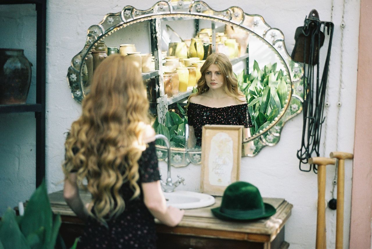 GIRL AND WOMAN STANDING ON SHELF