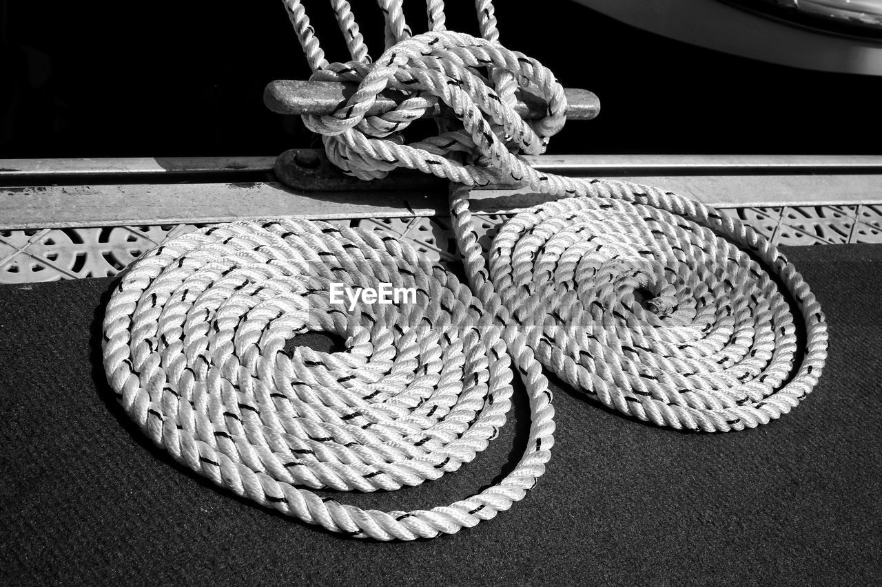 Close-up of curled up rope in boat