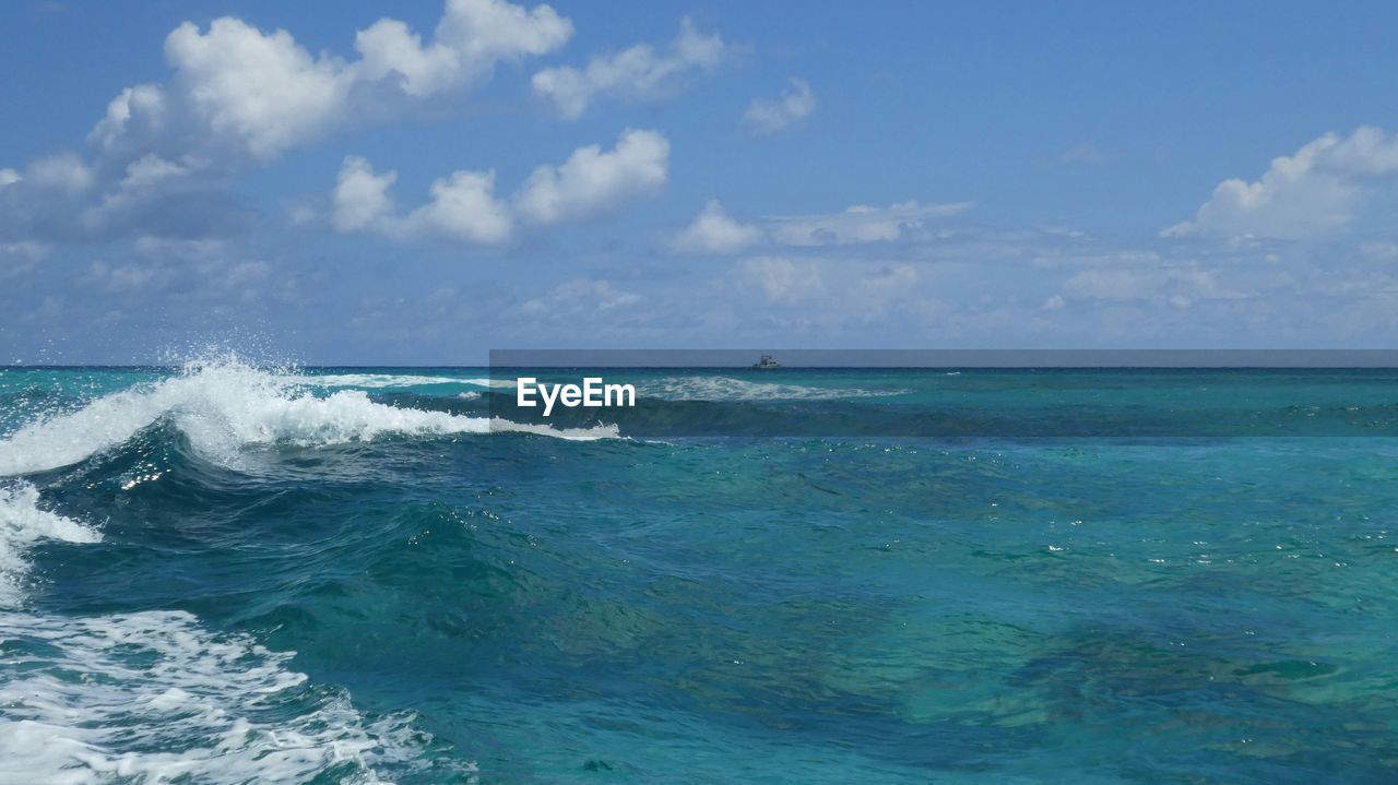 Scenic view of turquoise sea against blue sky