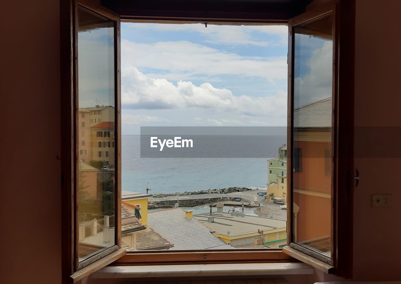 SCENIC VIEW OF SEA SEEN THROUGH WINDOW