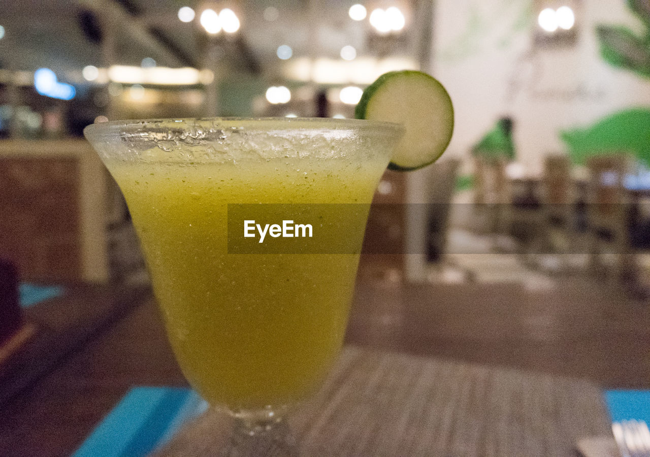 CLOSE-UP OF DRINK WITH TABLE
