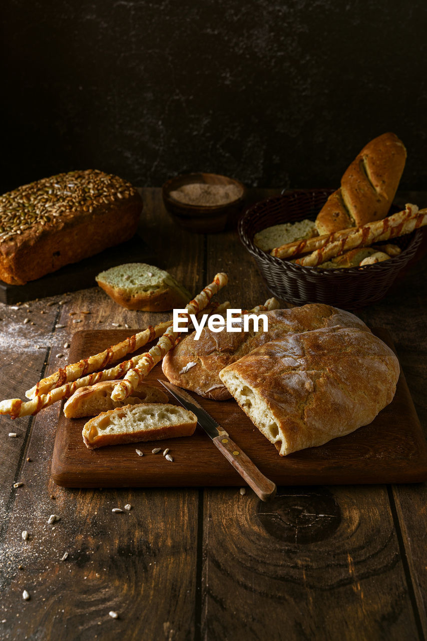 Variety of home baked breads on dark rustic background