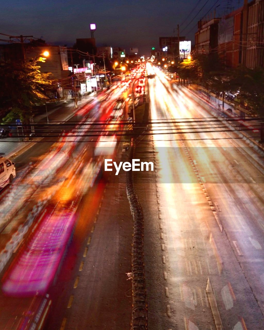 HIGH ANGLE VIEW OF LIGHT TRAILS ON ROAD