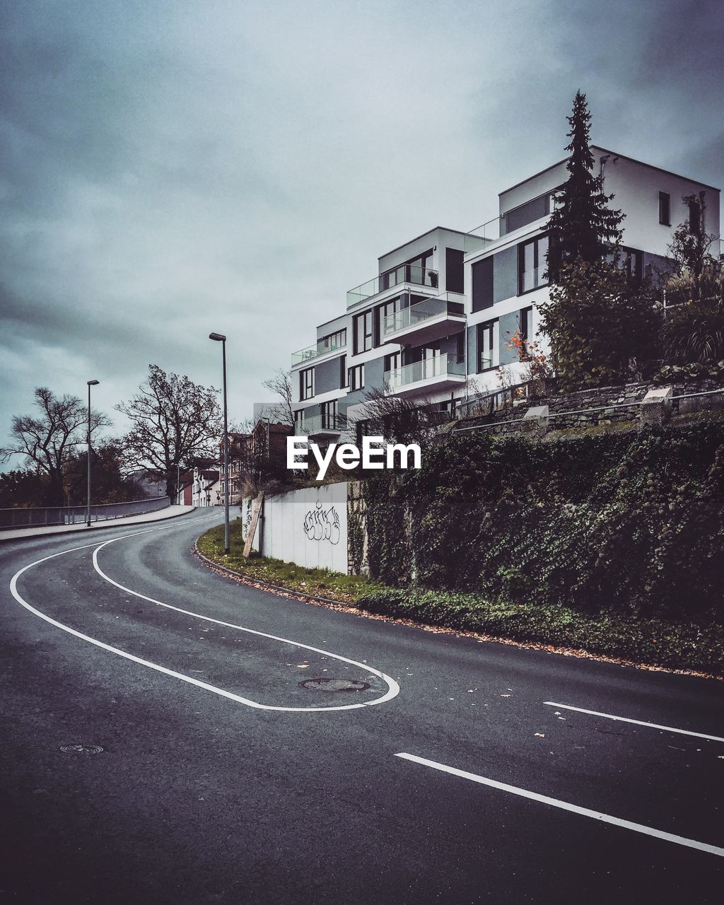 EMPTY ROAD AGAINST BUILDINGS