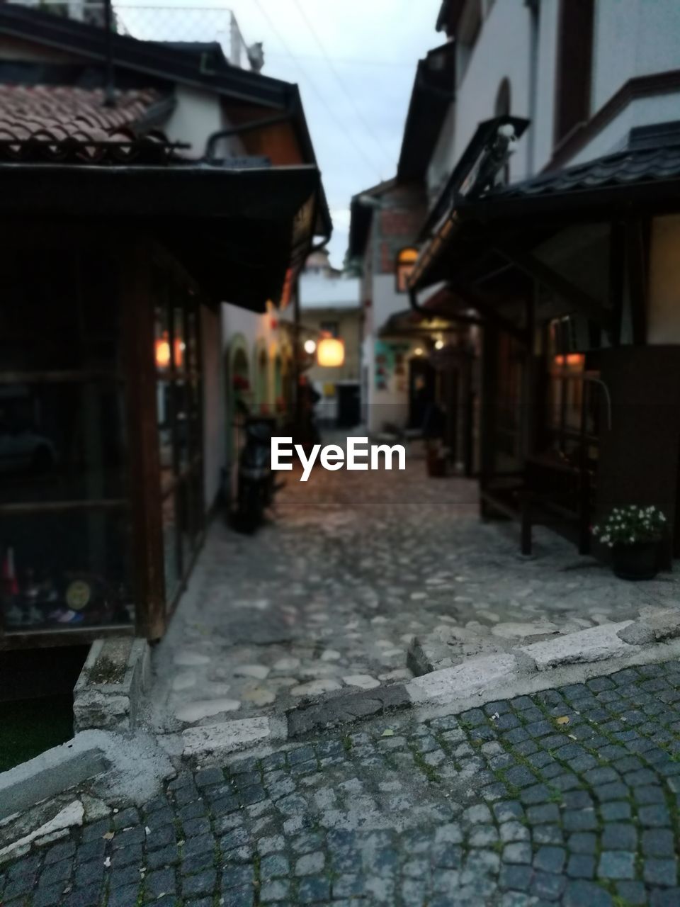 VIEW OF NARROW STREET ALONG BUILDINGS