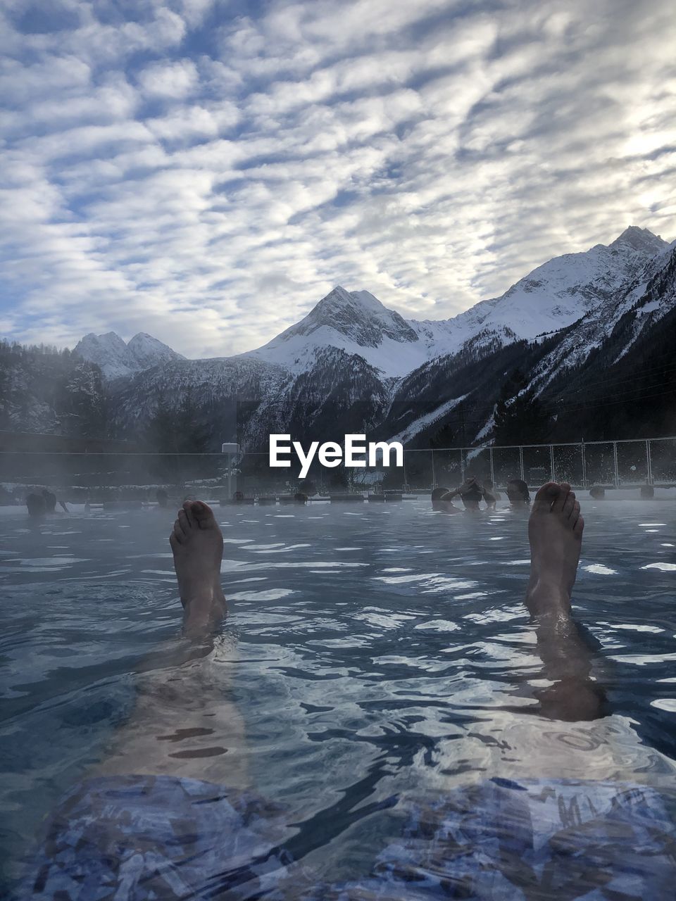 PEOPLE ON SNOWCAPPED MOUNTAIN AGAINST SKY