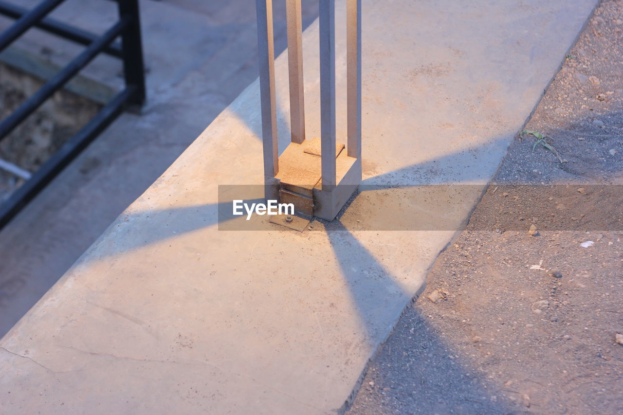 HIGH ANGLE VIEW OF FOOTPATH BY SHADOW ON FLOOR