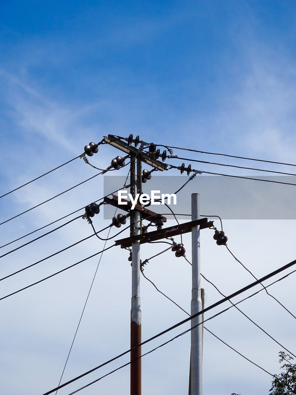 Low angle view of electricity pylon against sky