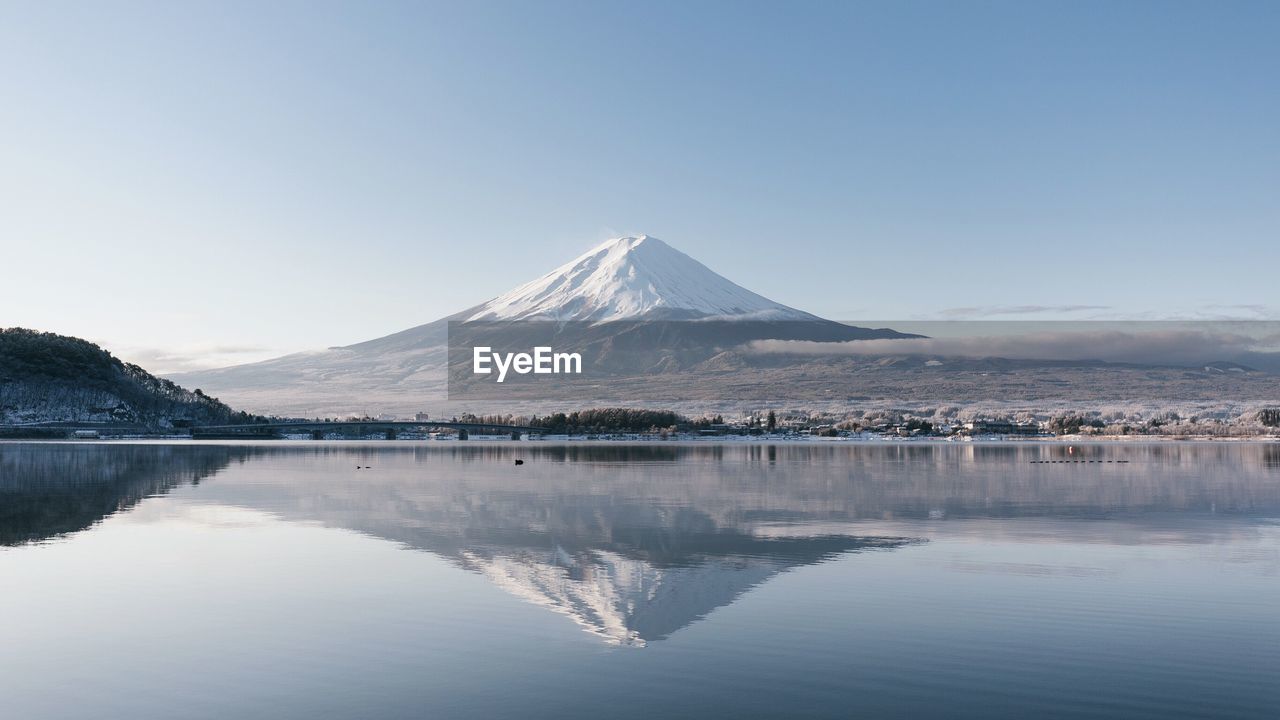 Scenic view of snowcapped mountain against cloudy sky