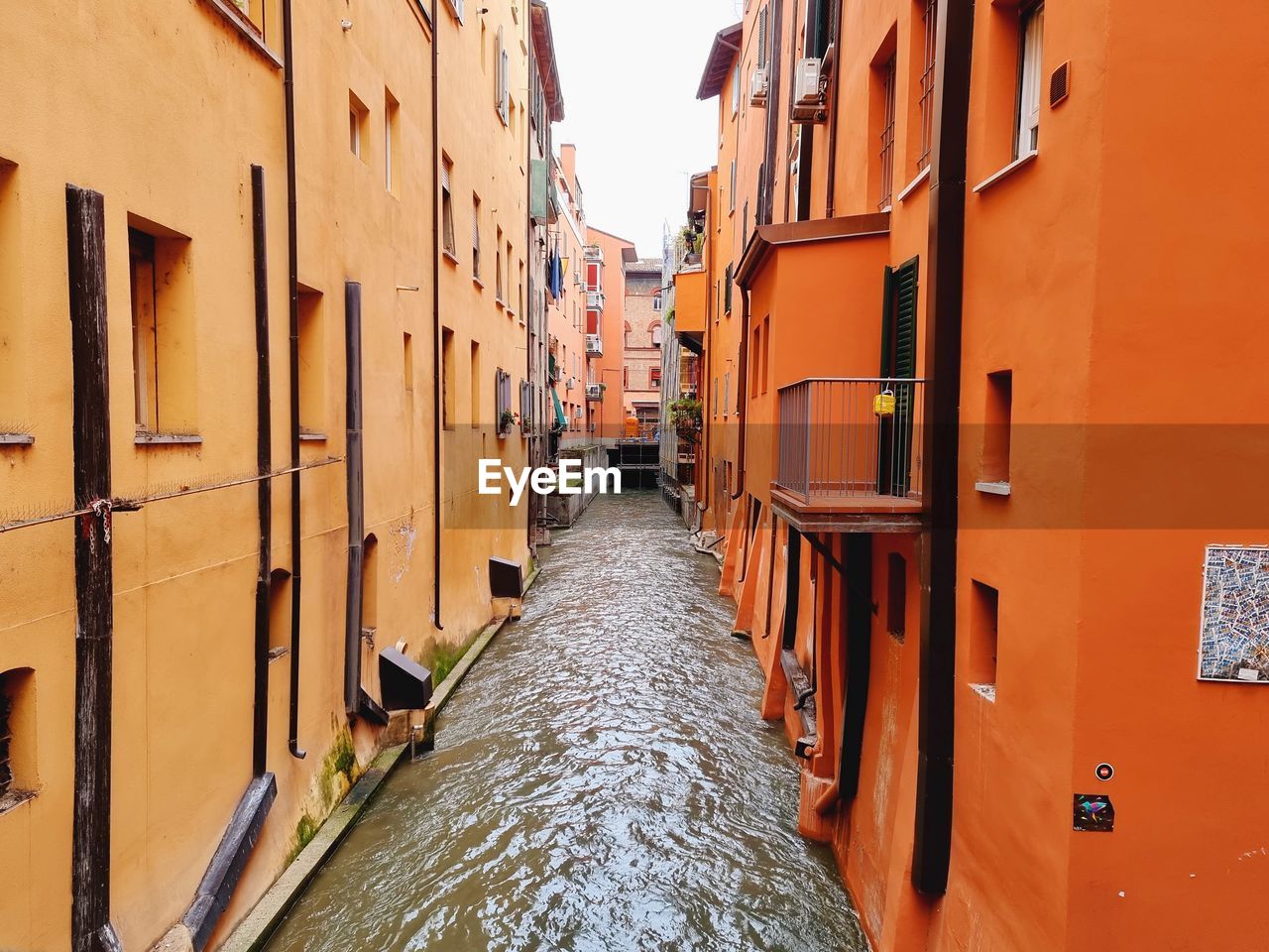 Narrow canal amidst buildings in city