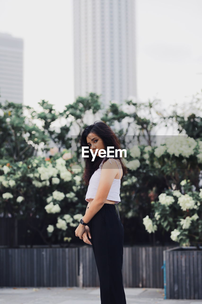 Portrait of woman standing in city