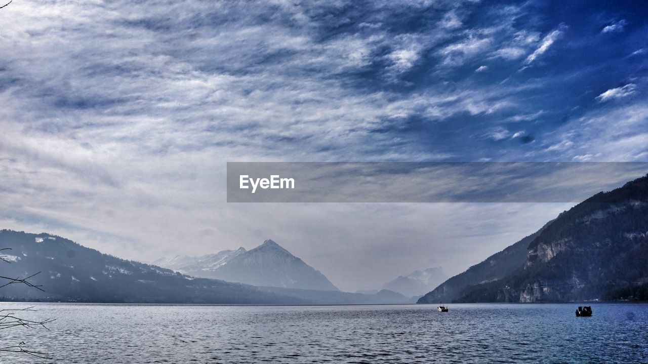 Scenic view of mountains against cloudy sky