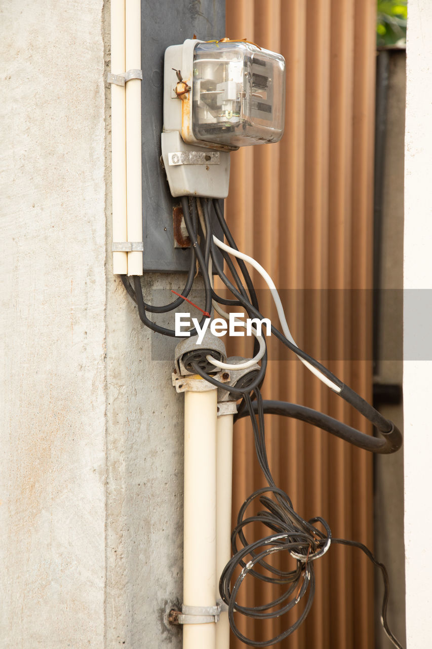 Electricity meter attached on the electrical concrete pole in thailand shows measuring electricity,