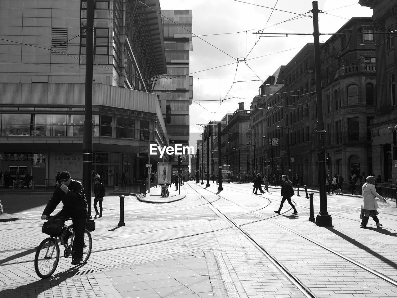 PEOPLE WALKING ON STREET IN CITY