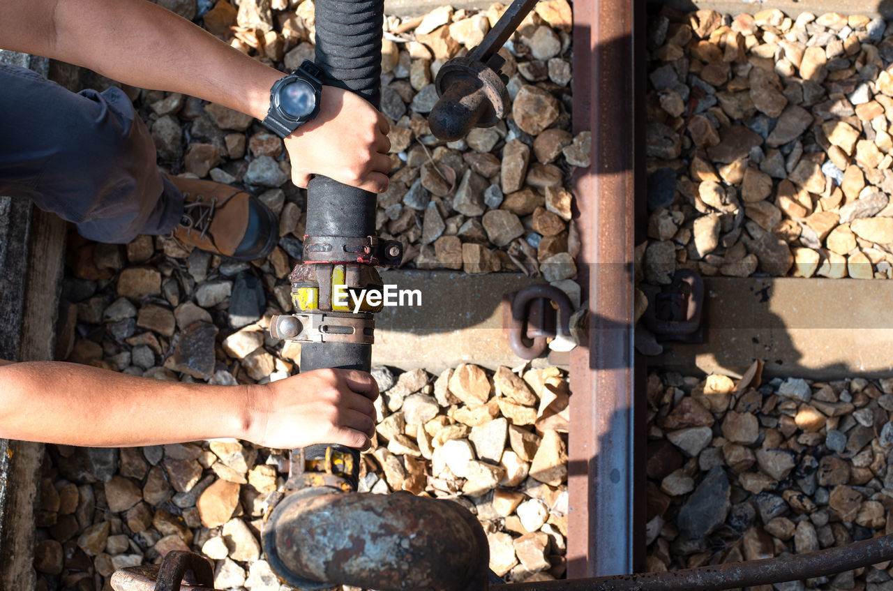 MIDSECTION OF MAN WORKING ON STONE