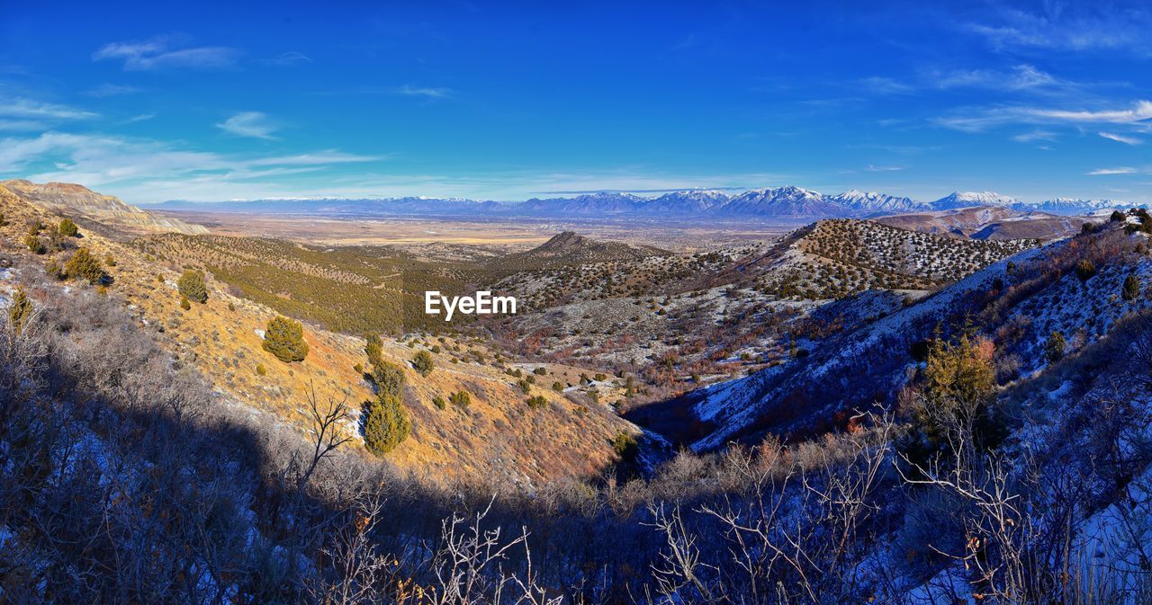 SCENIC VIEW OF LANDSCAPE AND MOUNTAINS AGAINST BLUE SKY