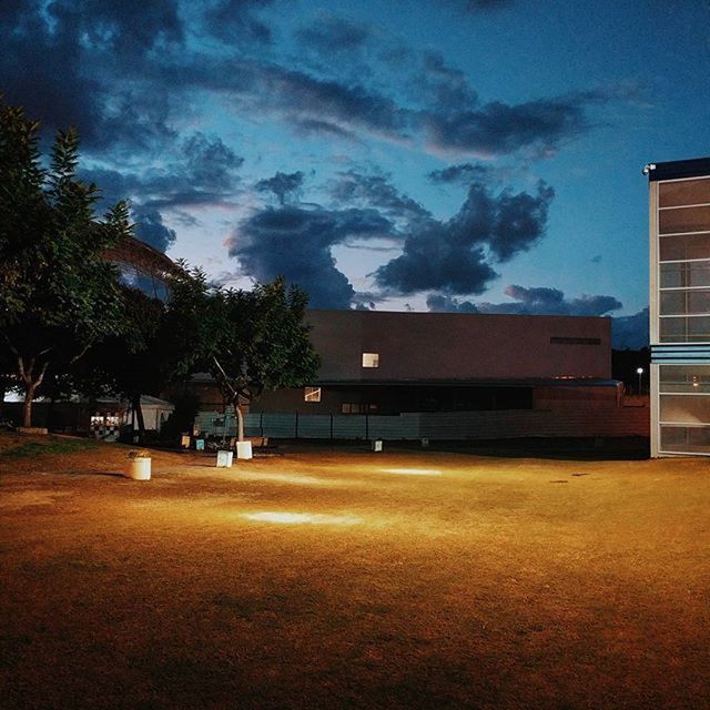 VIEW OF ILLUMINATED BUILDINGS AGAINST CLOUDY SKY