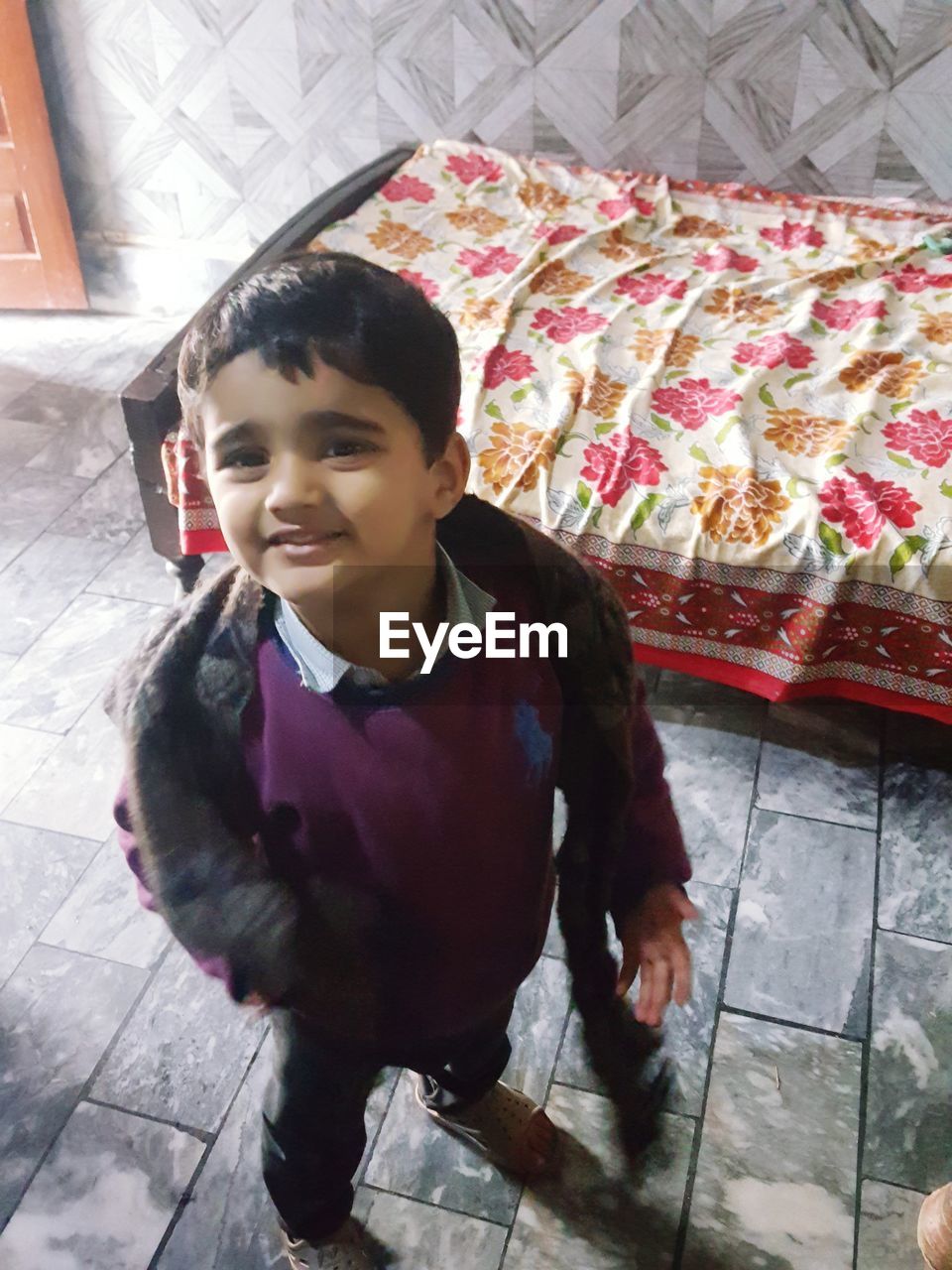 HIGH ANGLE PORTRAIT OF BOY AT HOME