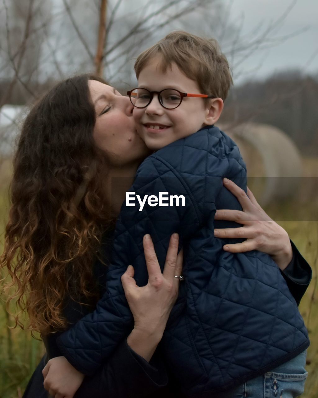 Close-up of mother kissing son outdoors