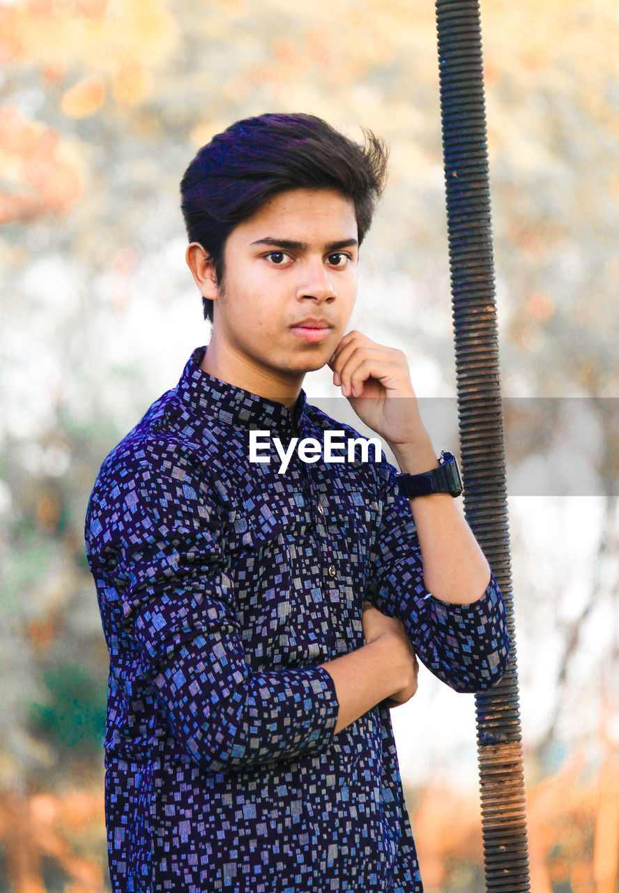 Portrait of young man standing outdoors