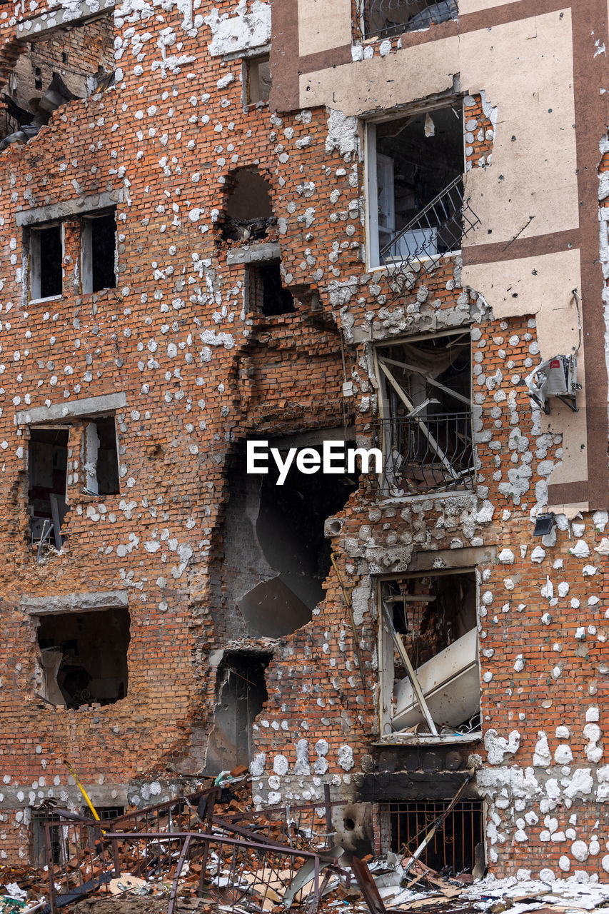 Cities of ukraine after the russian occupation. destroyed buildings on the streets of irpen.