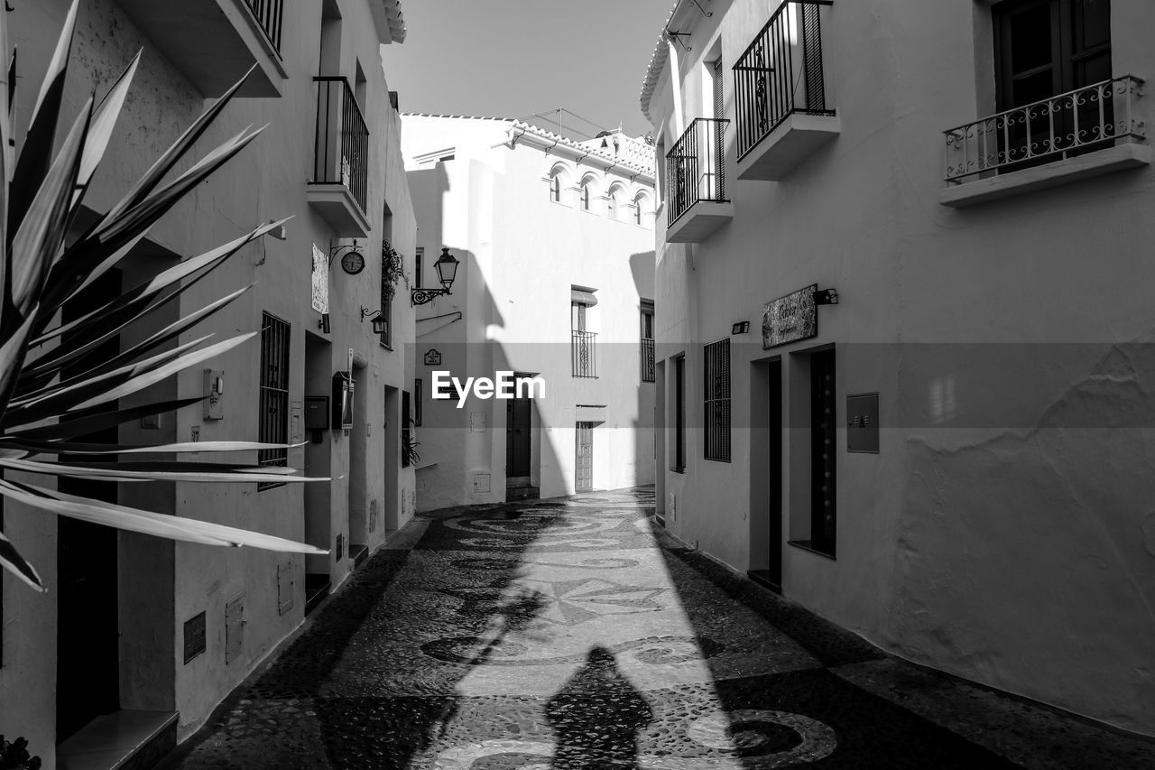 Narrow alley amidst buildings in town