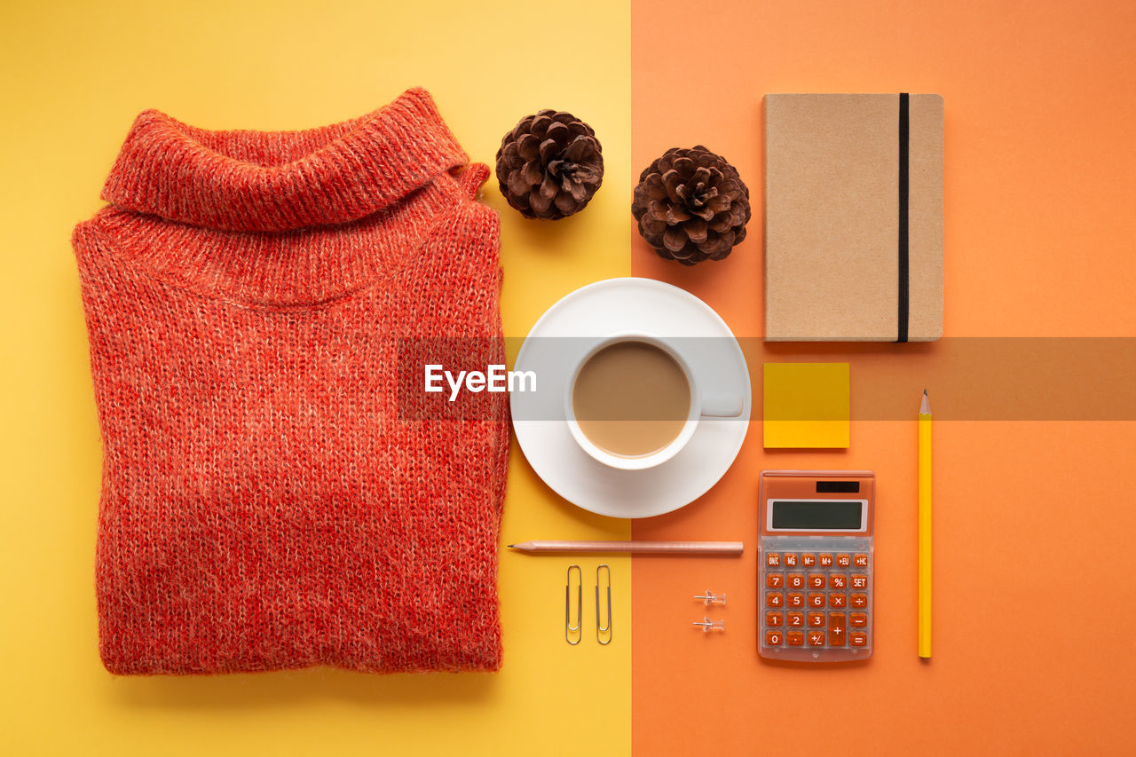 HIGH ANGLE VIEW OF COFFEE CUP ON BOOK