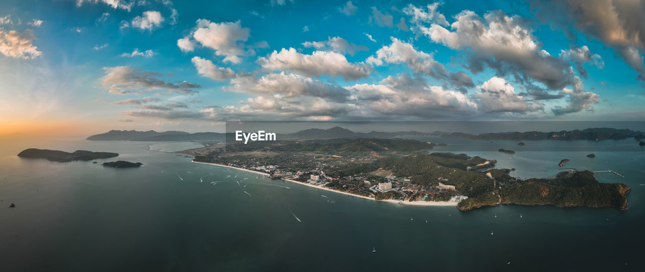 high angle view of sea and buildings against sky during sunset