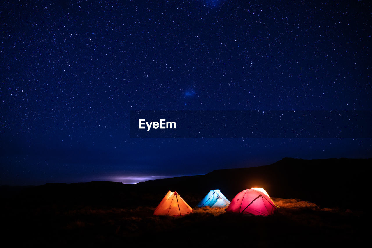 Low angle view of mountain against sky at night with stars, drakensberg. 