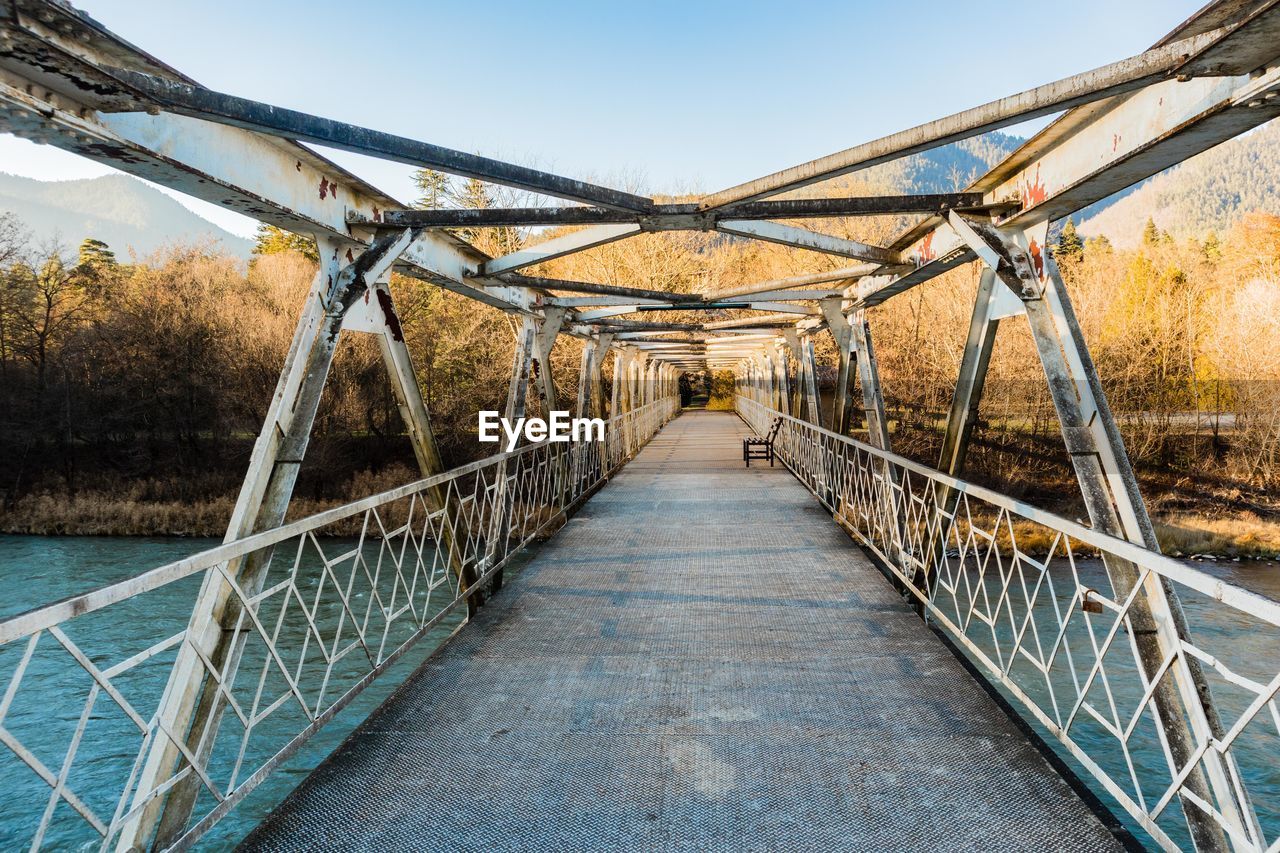Steel bridge over the river in the mountains at morning