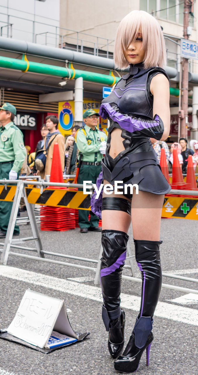 FULL LENGTH OF WOMAN STANDING ON ROAD