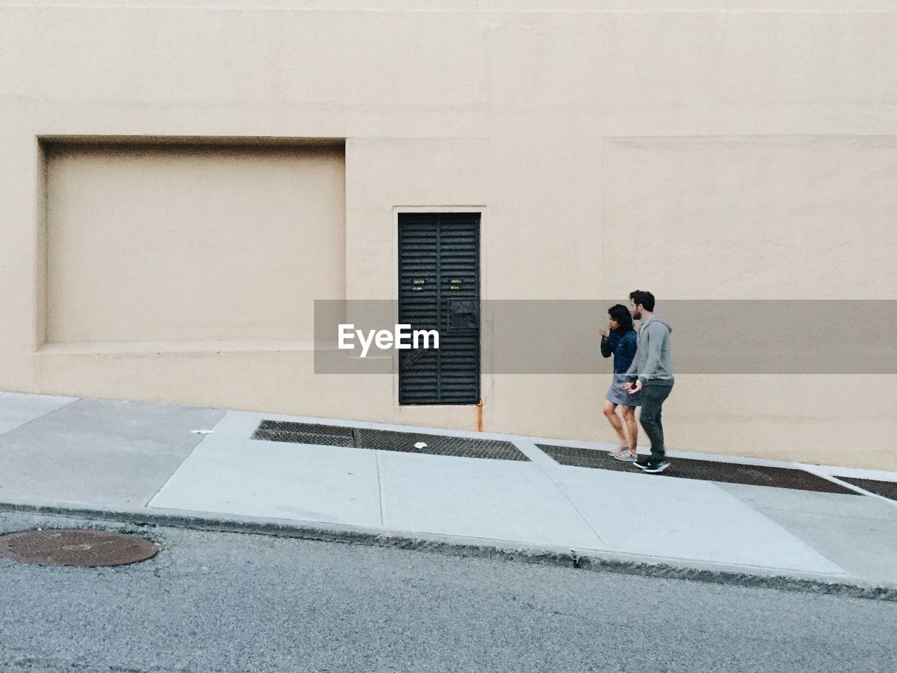 Full length of young couple walking in city